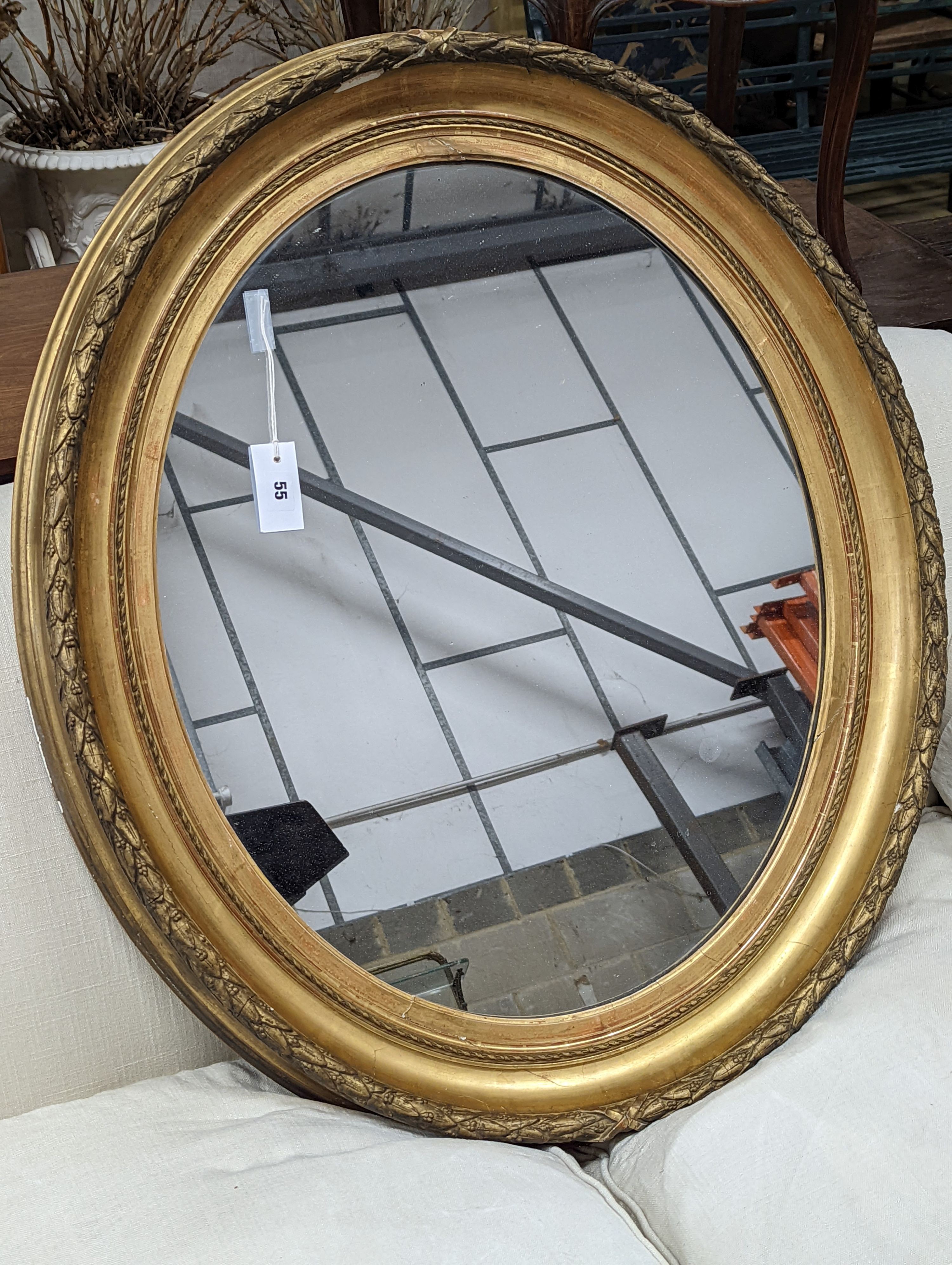 A Victorian oval giltwood and gesso wall mirror, width 80cm, height 94cm